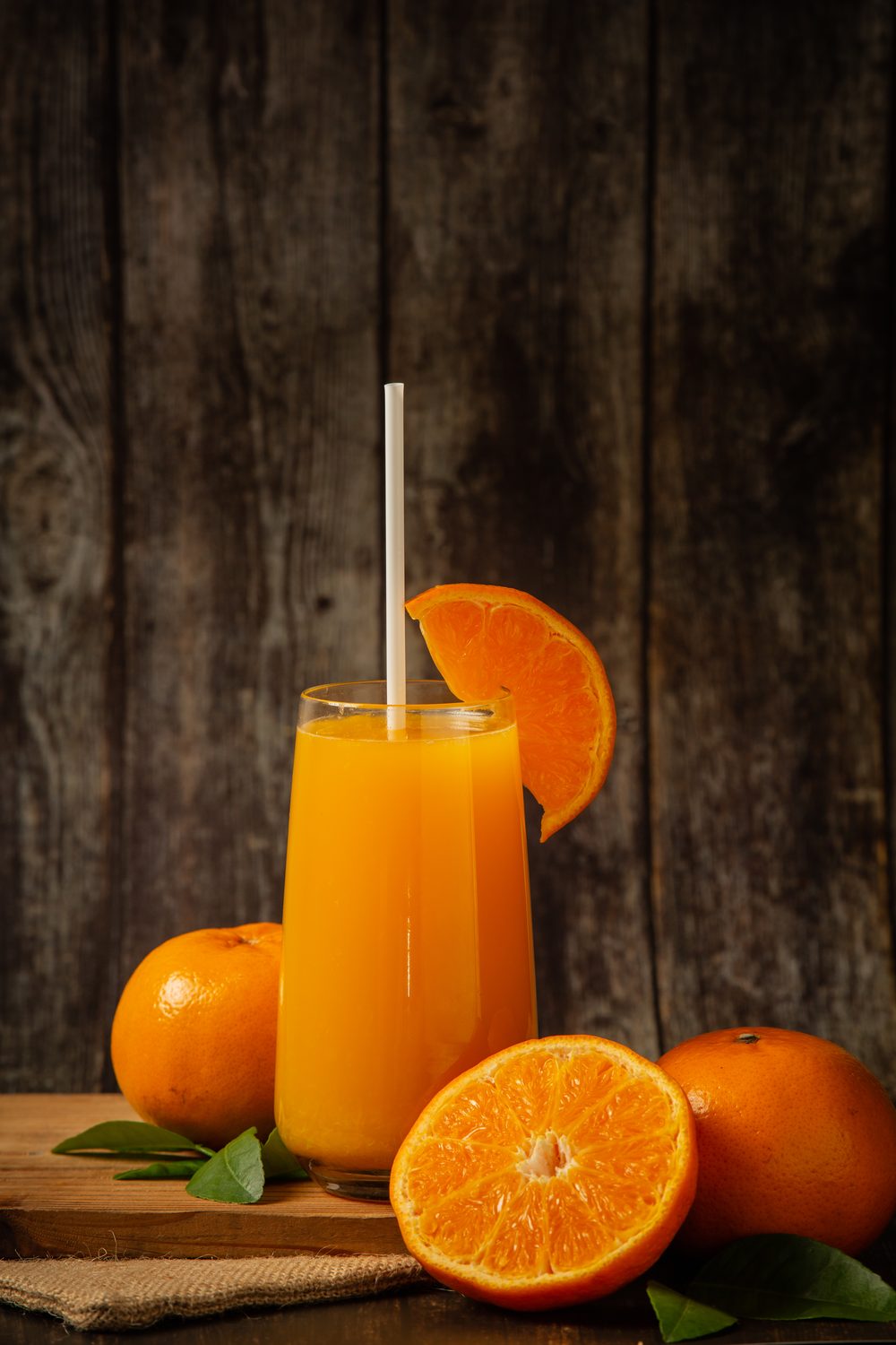 Glass of fresh orange juice with oranges